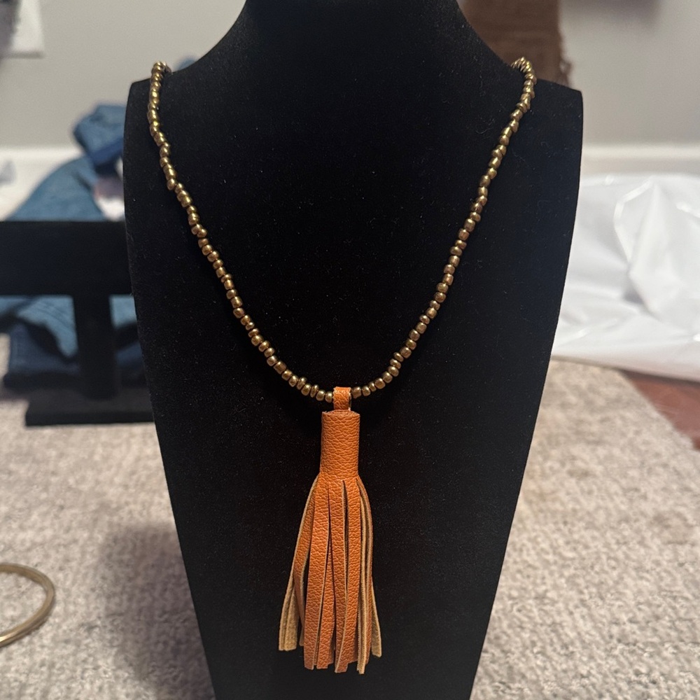 21” Gold Beaded Necklace with Leather Orange Tassel